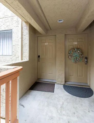 a kitchen with stainless steel appliances granite countertop a stove a sink a refrigerator and a dining table with wooden floor