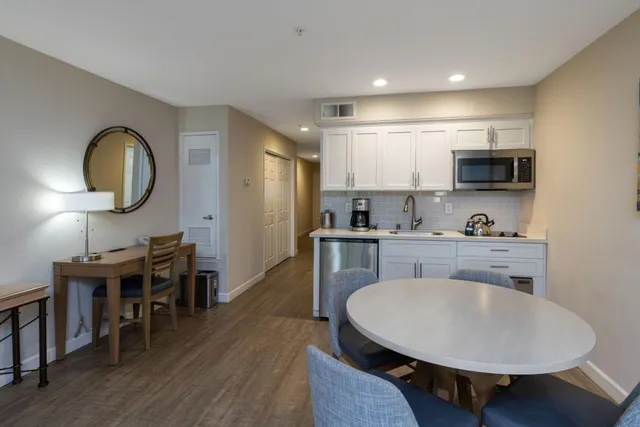 a kitchen with stainless steel appliances granite countertop a sink and a microwave