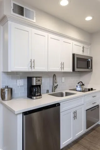 a living room with furniture and a mirror