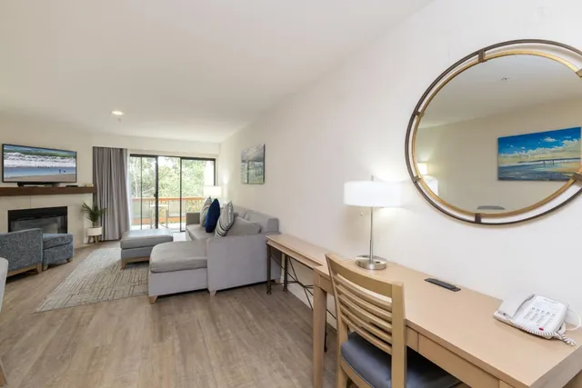 a living room with furniture a flat screen tv and a fireplace