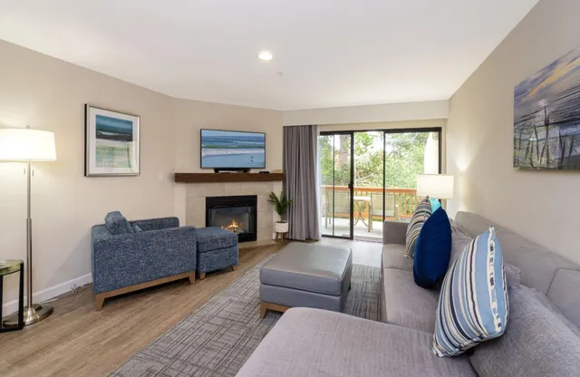 a living room with furniture and kitchen view