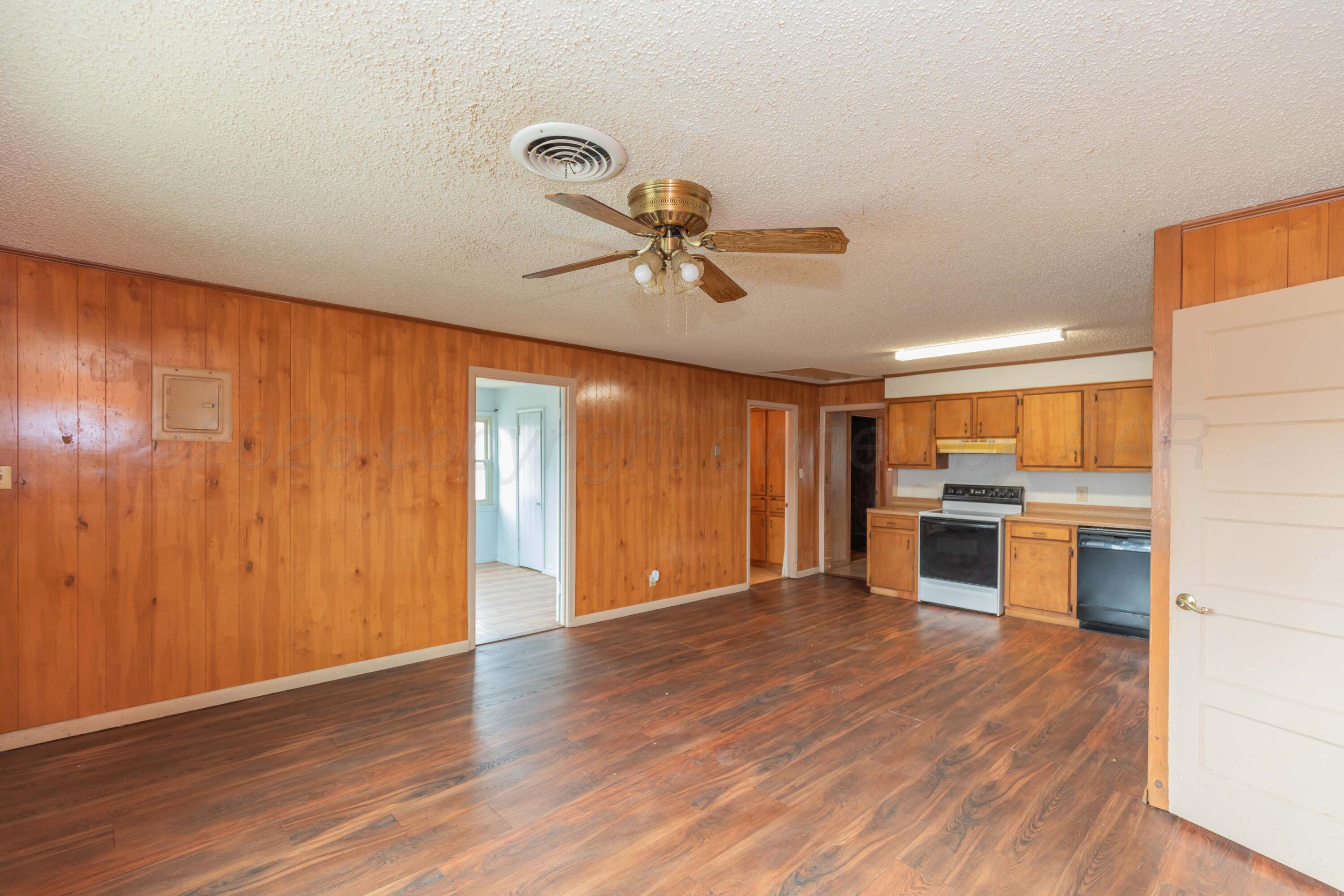 200 South Wall Street Shamrock, TX 79079 - Photo 12 of 40 a view of an empty room with a window and wooden floor
