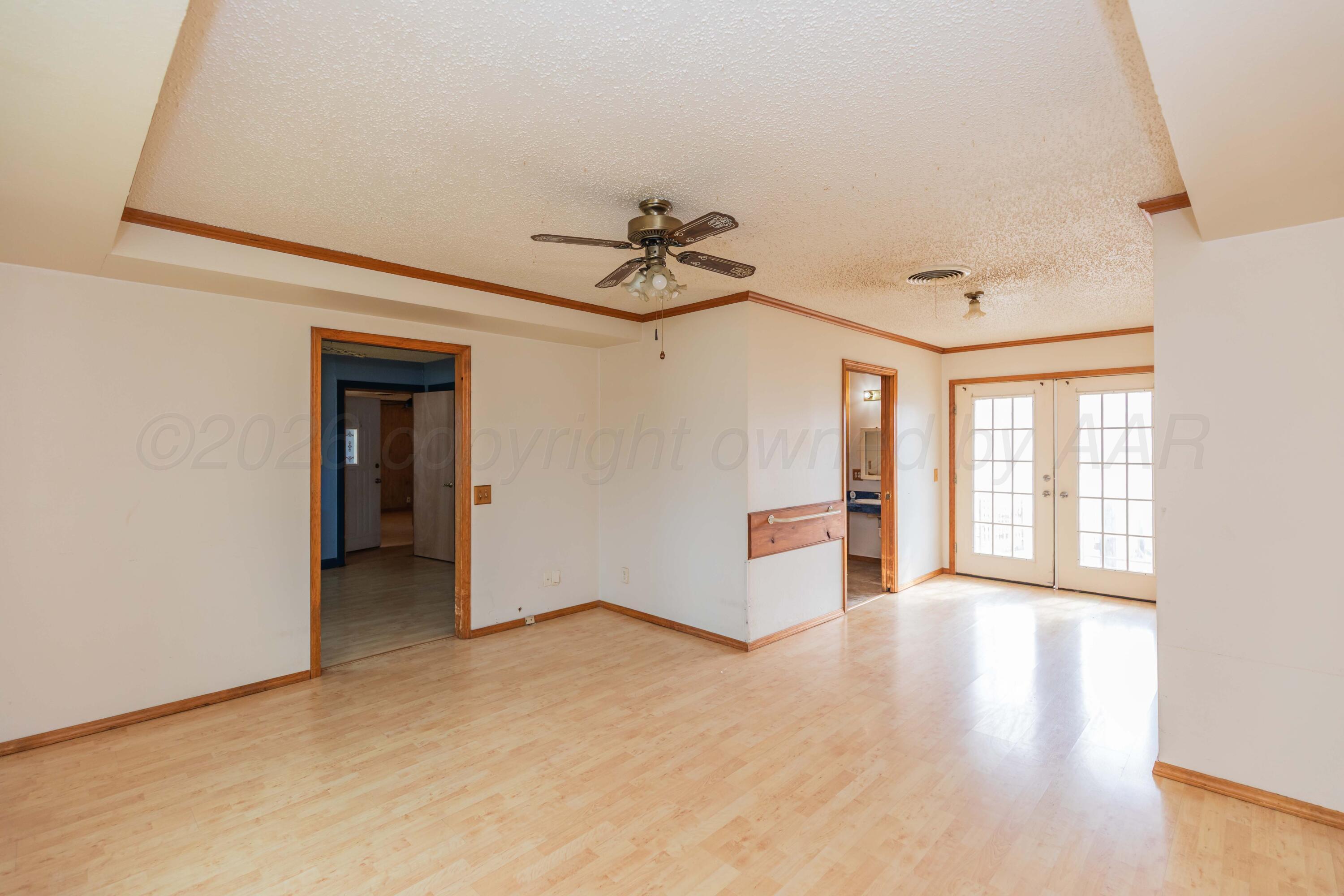 200 South Wall Street Shamrock, TX 79079 - Photo 14 of 40 a view of a livingroom with a ceiling fan and window