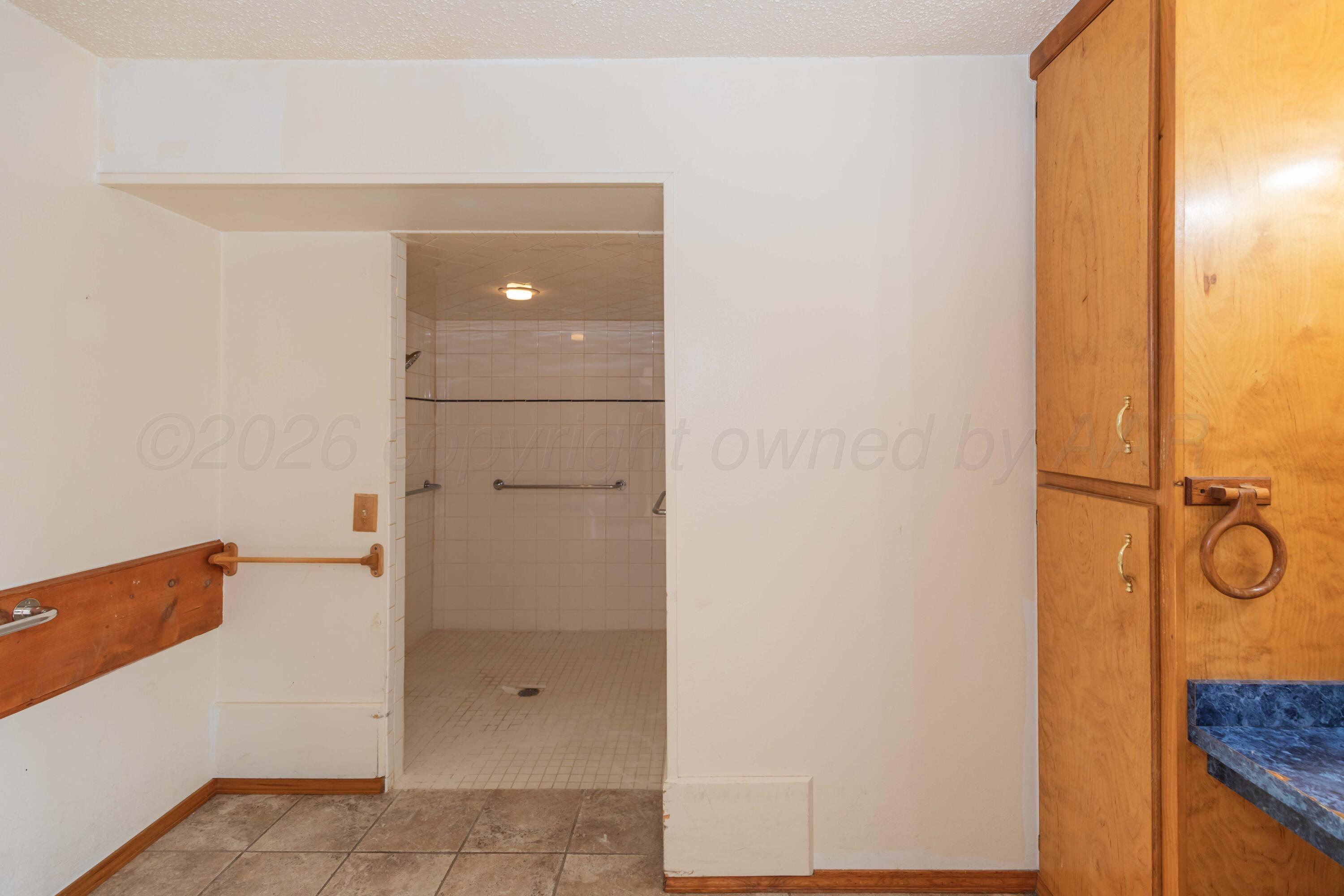 200 South Wall Street Shamrock, TX 79079 - Photo 18 of 40 a bathroom with a granite countertop shower