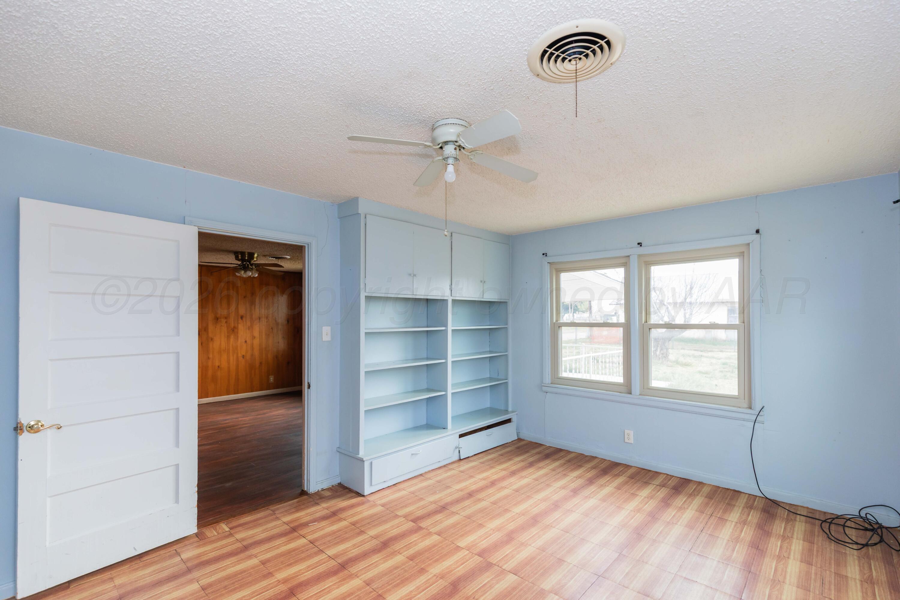 200 South Wall Street Shamrock, TX 79079 - Photo 29 of 40 a view of an empty room with a window and wooden floor