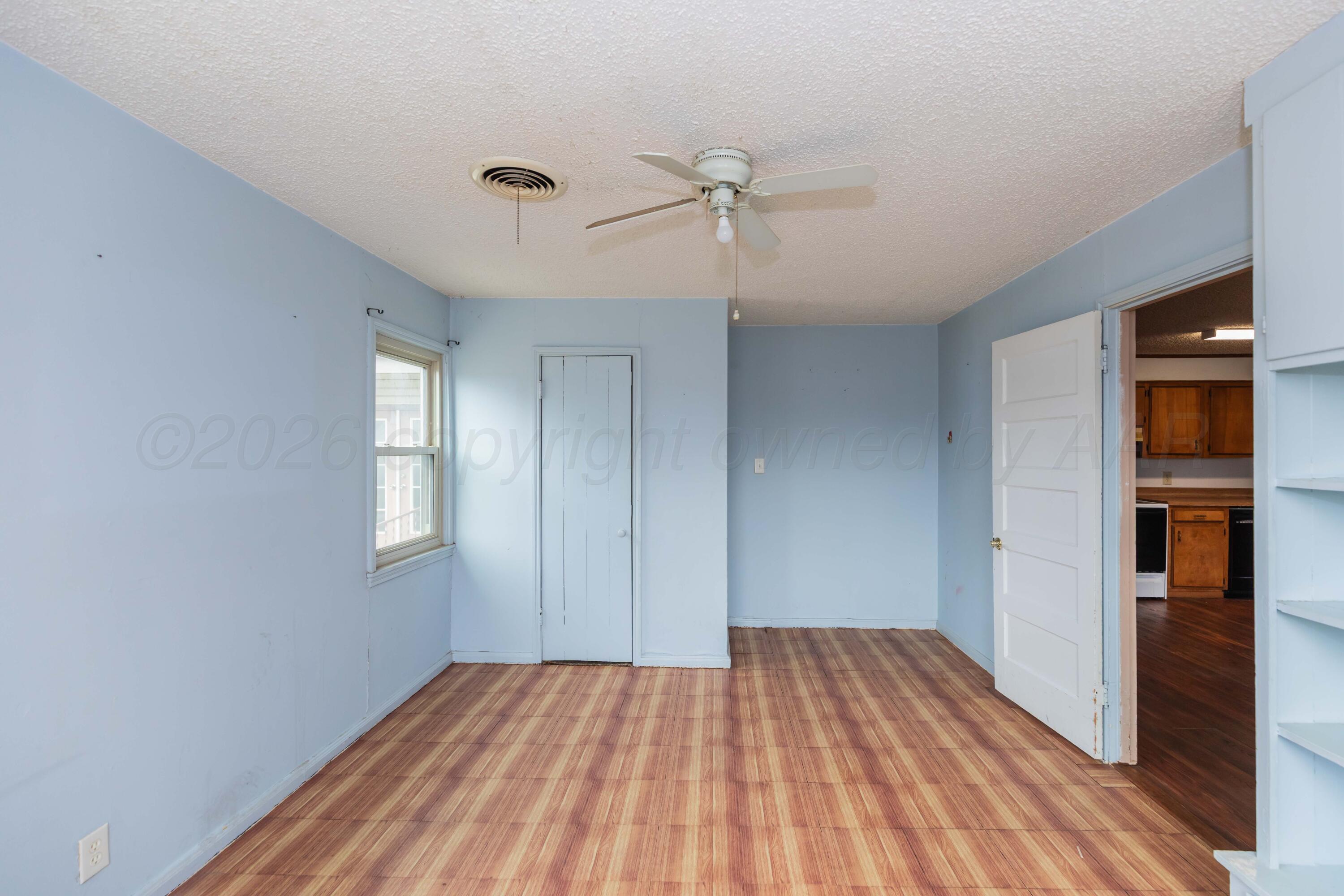 200 South Wall Street Shamrock, TX 79079 - Photo 31 of 40 a view of empty room with wooden floor and fan