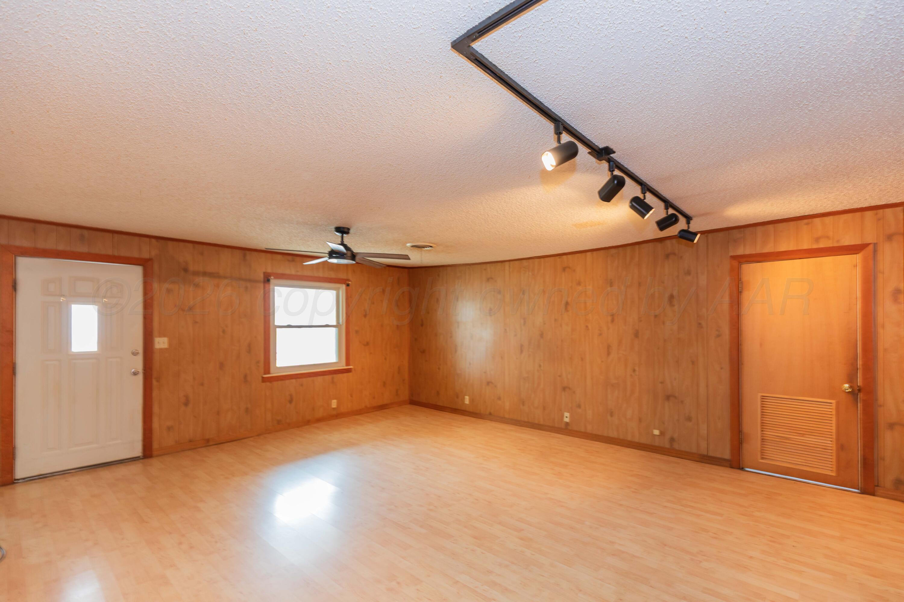 200 South Wall Street Shamrock, TX 79079 - Photo 4 of 40 an empty room with windows and ceiling fan
