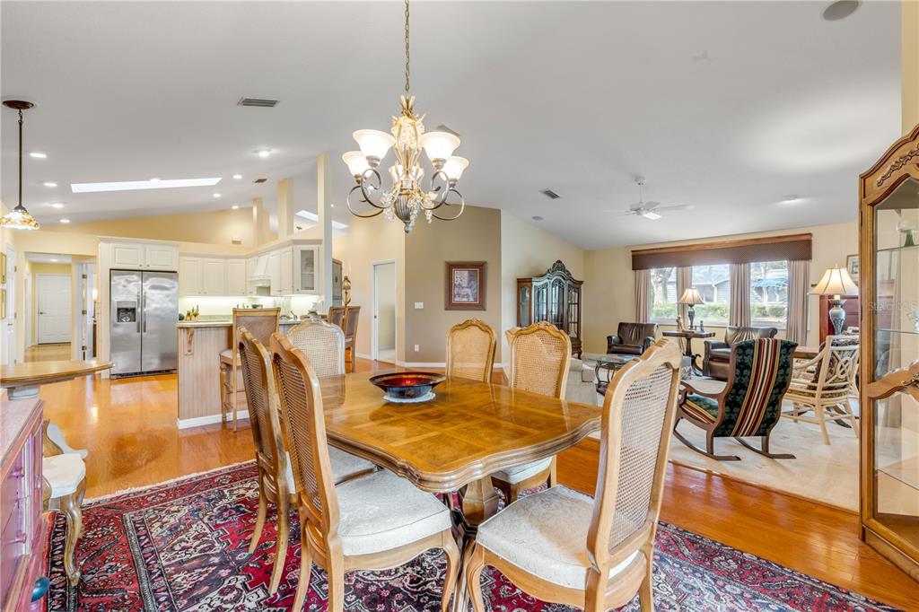 1098 Red Maple Way New Smyrna Beach, FL 32168 - Photo 14 of 78 a view of a dining room and livingroom with furniture wooden floor a chandelier