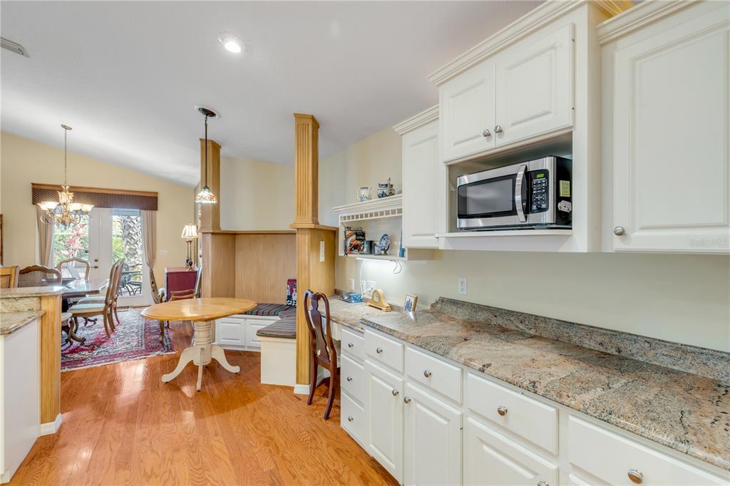 1098 Red Maple Way New Smyrna Beach, FL 32168 - Photo 21 of 78 a living room with stainless steel appliances kitchen island granite countertop furniture a rug and a view of kitchen
