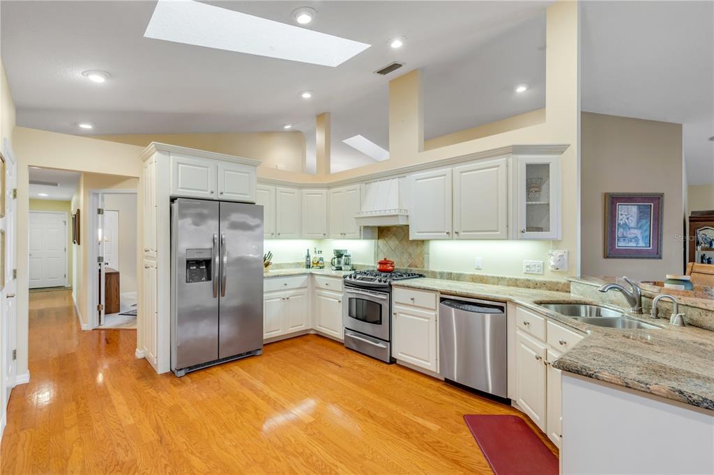 1098 Red Maple Way New Smyrna Beach, FL 32168 - Photo 23 of 78 a kitchen with stainless steel appliances granite countertop a sink stove and refrigerator