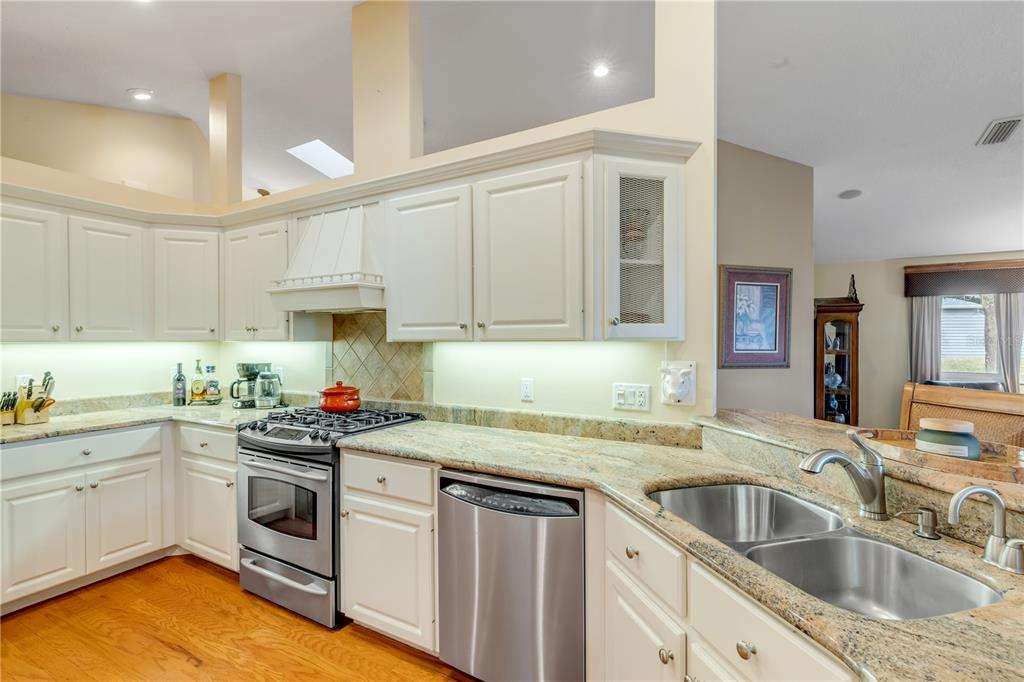 1098 Red Maple Way New Smyrna Beach, FL 32168 - Photo 24 of 78 a kitchen with white cabinets sink and white appliances
