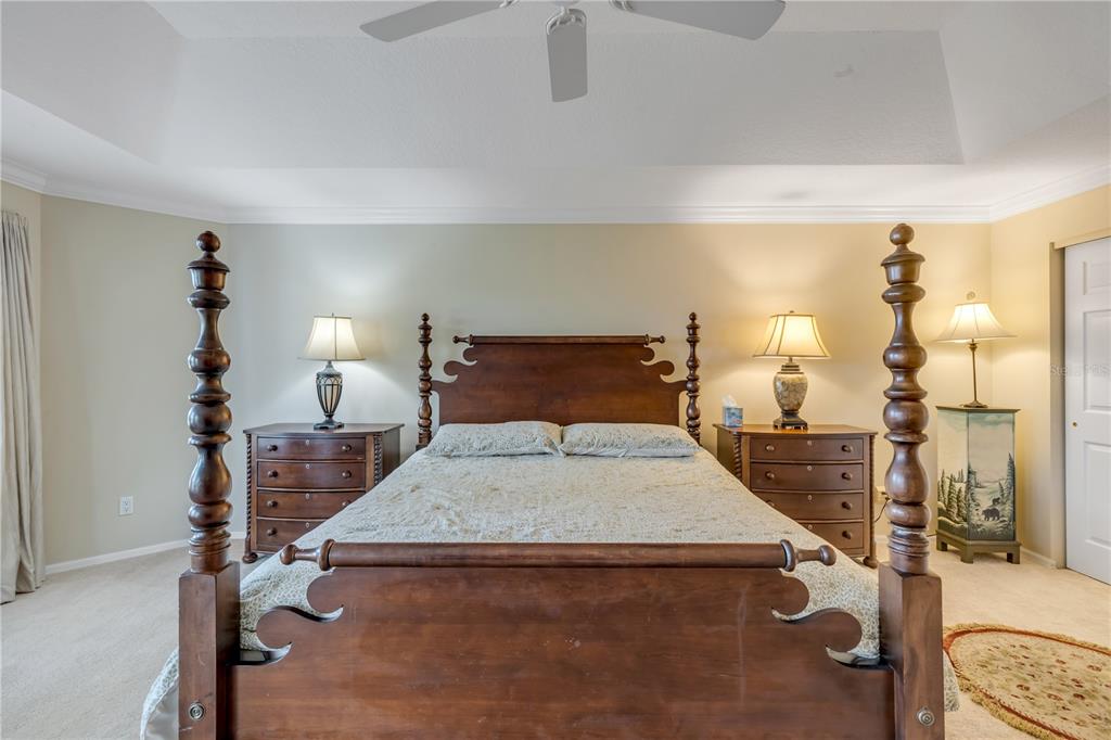 1098 Red Maple Way New Smyrna Beach, FL 32168 - Photo 27 of 78 a bedroom with a bed and wooden floor