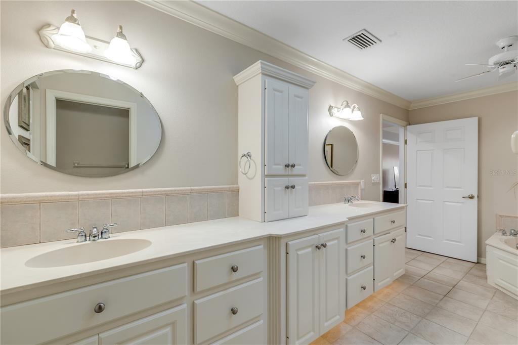 1098 Red Maple Way New Smyrna Beach, FL 32168 - Photo 32 of 78 a bathroom with a double vanity sink and a mirror