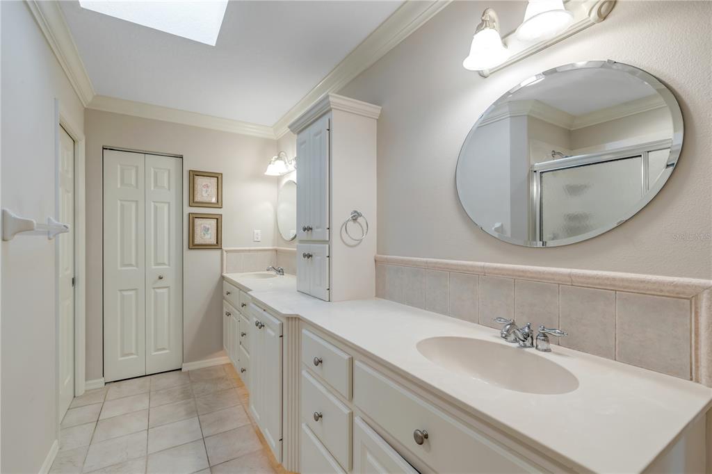 1098 Red Maple Way New Smyrna Beach, FL 32168 - Photo 35 of 78 a spacious bathroom with a double vanity sink and a mirror