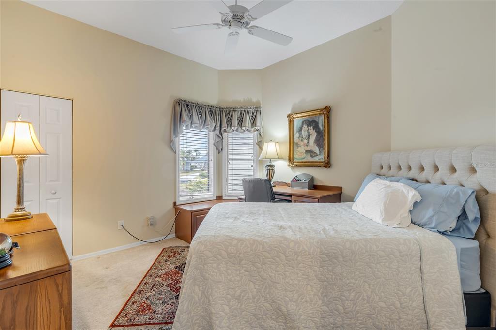 1098 Red Maple Way New Smyrna Beach, FL 32168 - Photo 38 of 78 a bedroom with a large bed and a chandelier