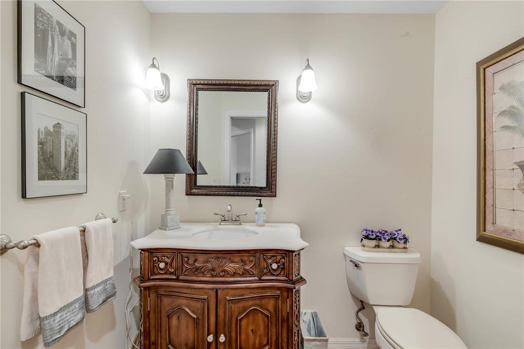 1098 Red Maple Way New Smyrna Beach, FL 32168 - Photo 40 of 78 a bathroom with a toilet a sink and mirror