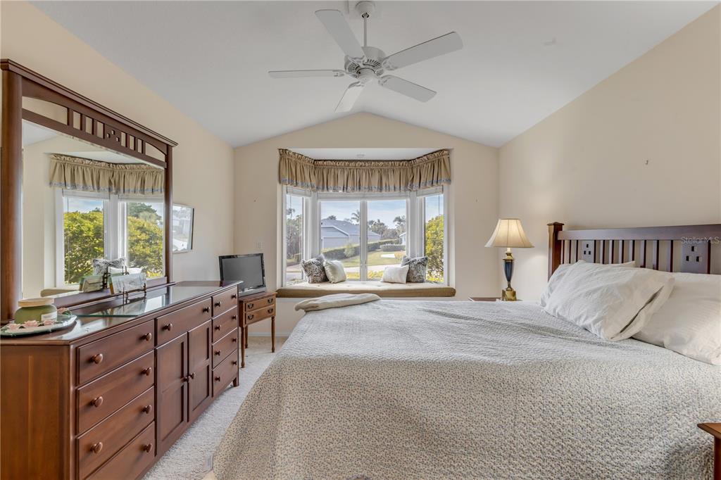 1098 Red Maple Way New Smyrna Beach, FL 32168 - Photo 44 of 78 a spacious bedroom with a large bed and a large window