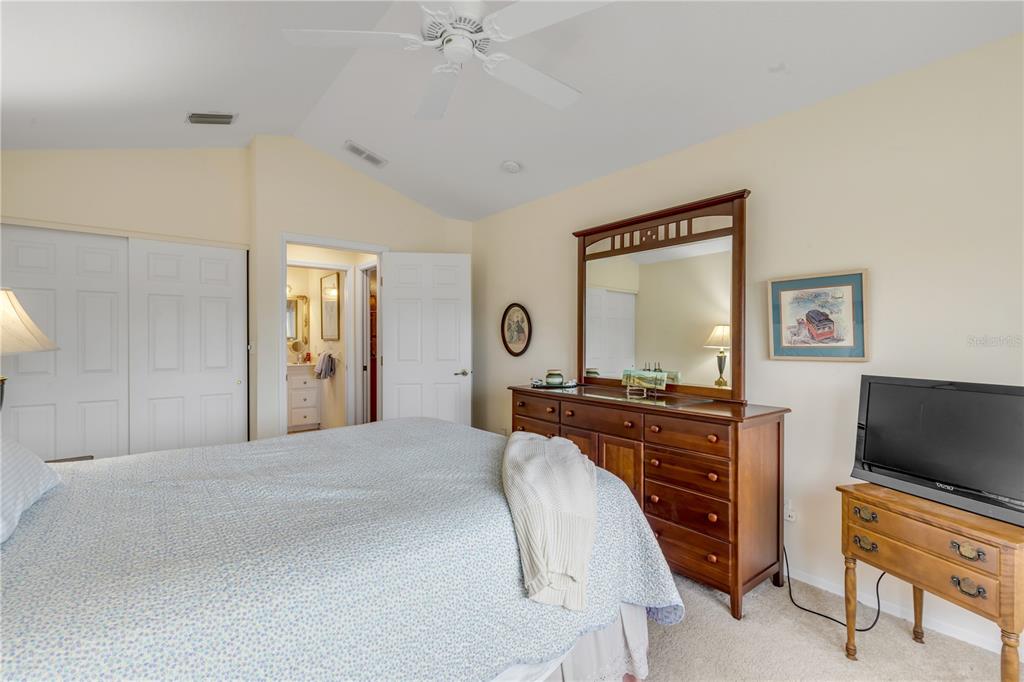 1098 Red Maple Way New Smyrna Beach, FL 32168 - Photo 45 of 78 a bedroom with a bed and a flat screen tv