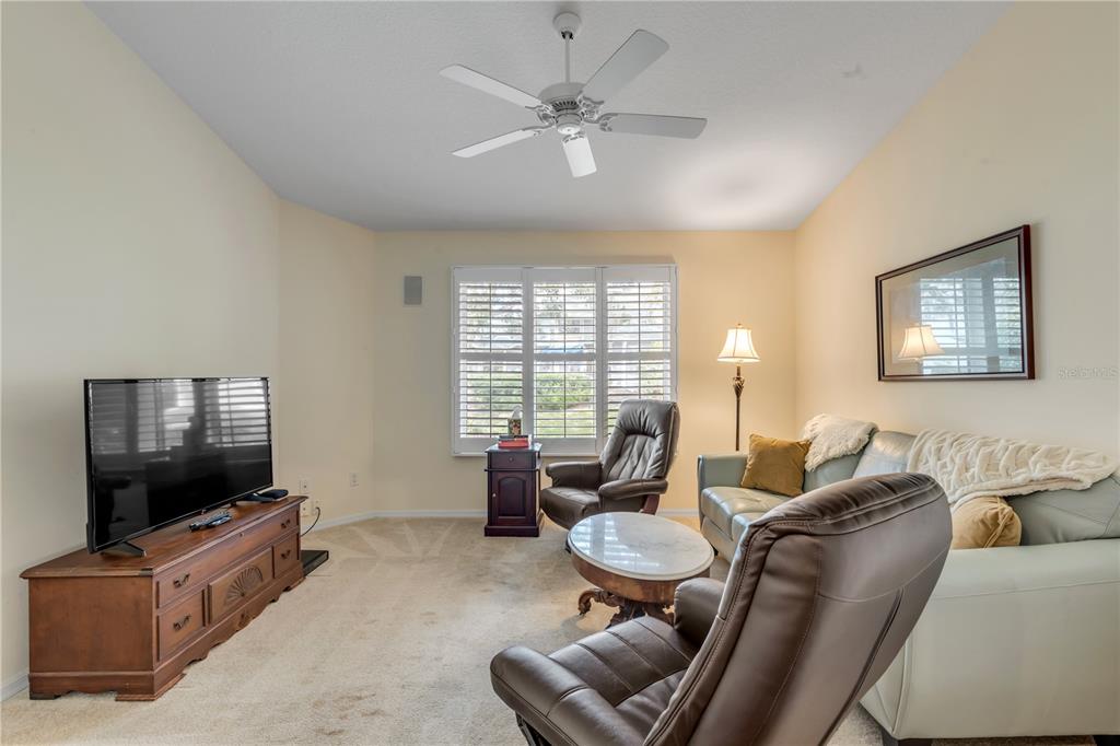 1098 Red Maple Way New Smyrna Beach, FL 32168 - Photo 47 of 78 a living room with furniture and a flat screen tv