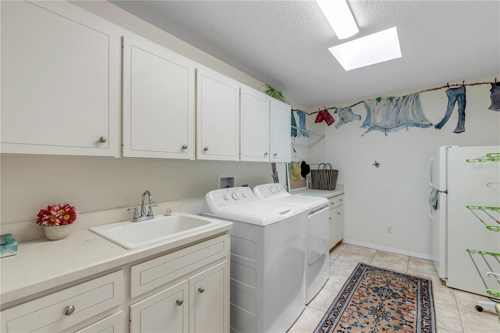 1098 Red Maple Way New Smyrna Beach, FL 32168 - Photo 50 of 78 a utility room with sink dryer and washer
