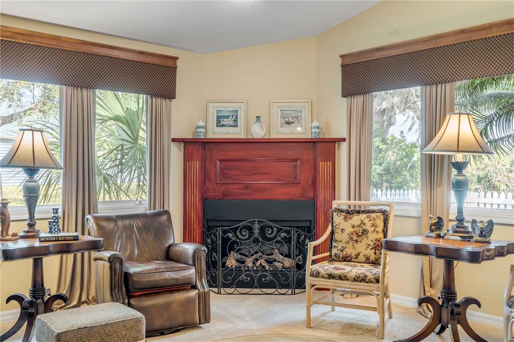 1098 Red Maple Way New Smyrna Beach, FL 32168 - Photo 6 of 78 a living room with furniture a large window and a fireplace