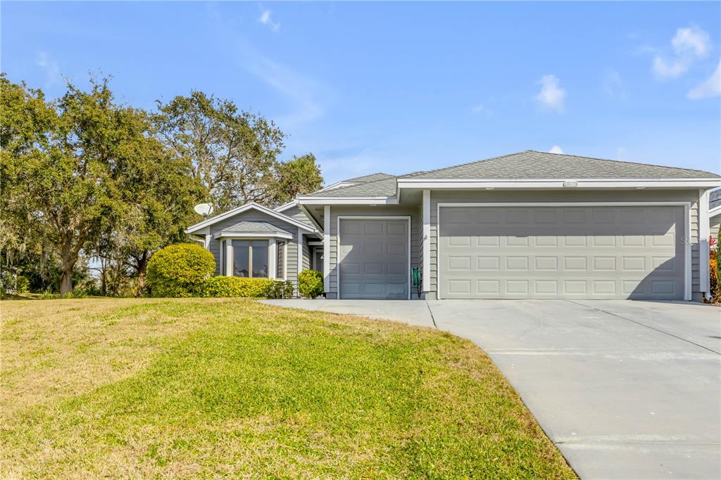 1098 Red Maple Way New Smyrna Beach, FL 32168 - Photo 67 of 78 a front view of house with yard and trees in the background