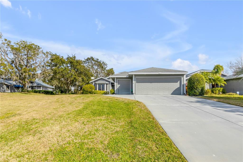 1098 Red Maple Way New Smyrna Beach, FL 32168 - Photo 75 of 78 a front view of a house with a yard and garage