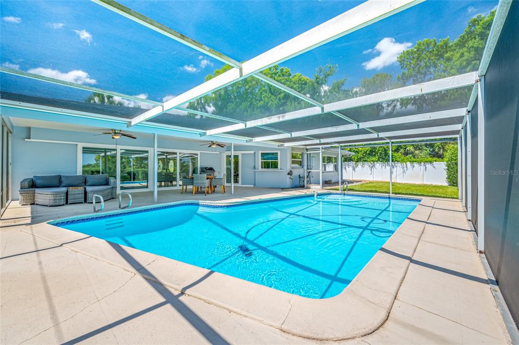 656 Mehlenbacher Road Belleair, FL 33756 - Photo 19 of 49 a view of swimming pool with seating area