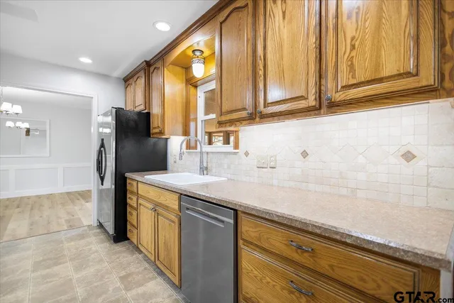 a kitchen with stainless steel appliances granite countertop a sink and cabinets