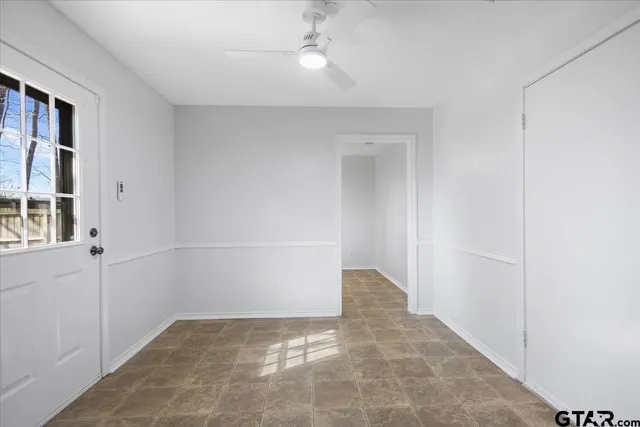 a large kitchen with stainless steel appliances granite countertop a refrigerator and a stove top oven