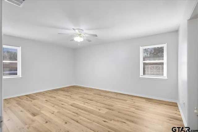 a view of an empty room with wooden floor