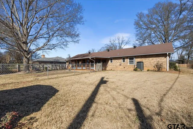 an aerial view of house with yard and mountain view in back