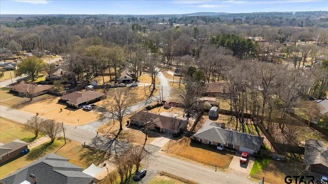 a aerial view of a house with a yard and garage