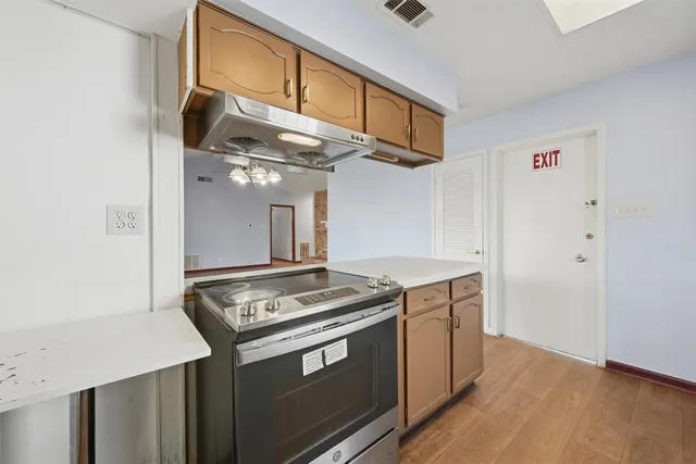 a kitchen with stainless steel appliances granite countertop a stove and a refrigerator