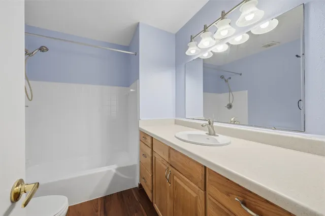 a bathroom with a sink a tub and a mirror