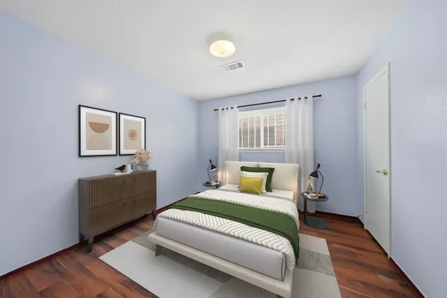 a bedroom with a bed and a couch