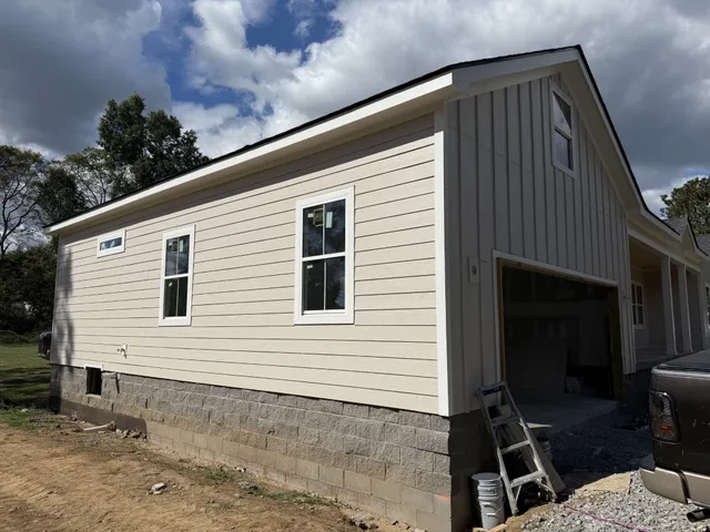 a view of backyard with a chair and potted plants