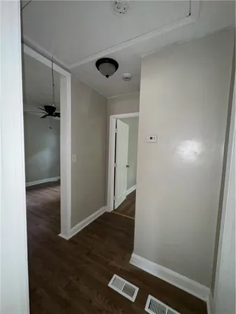 an empty room with wooden floor and closet