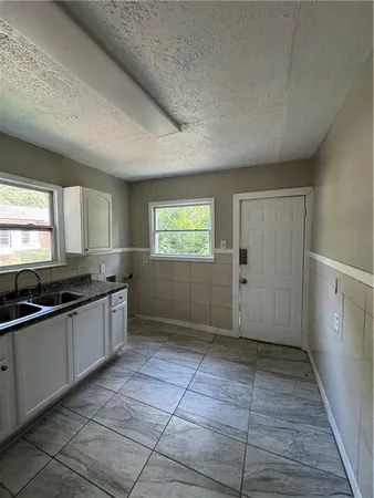 a kitchen with stainless steel appliances granite countertop a sink stove and cabinets