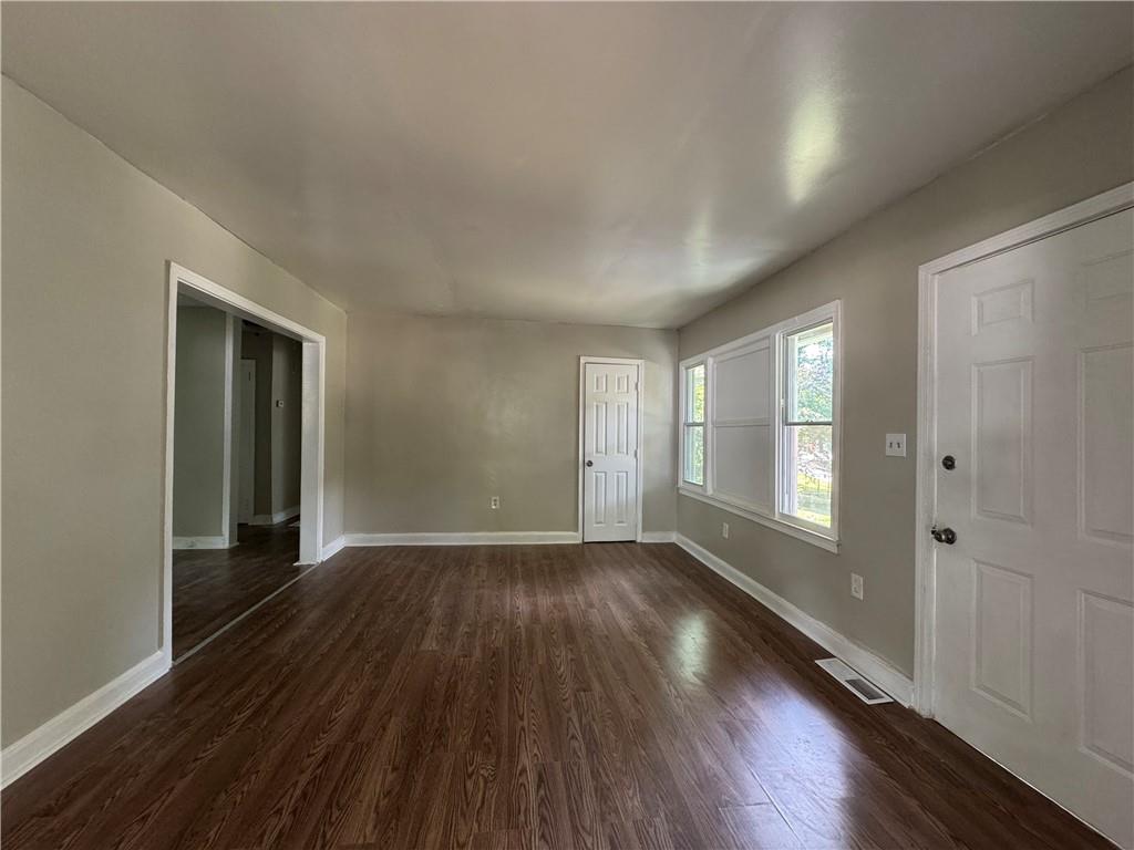 1537 Orlando Street Southwest Atlanta, GA 30311 - Photo 6 of 16 a view of an empty room with wooden floor and a window