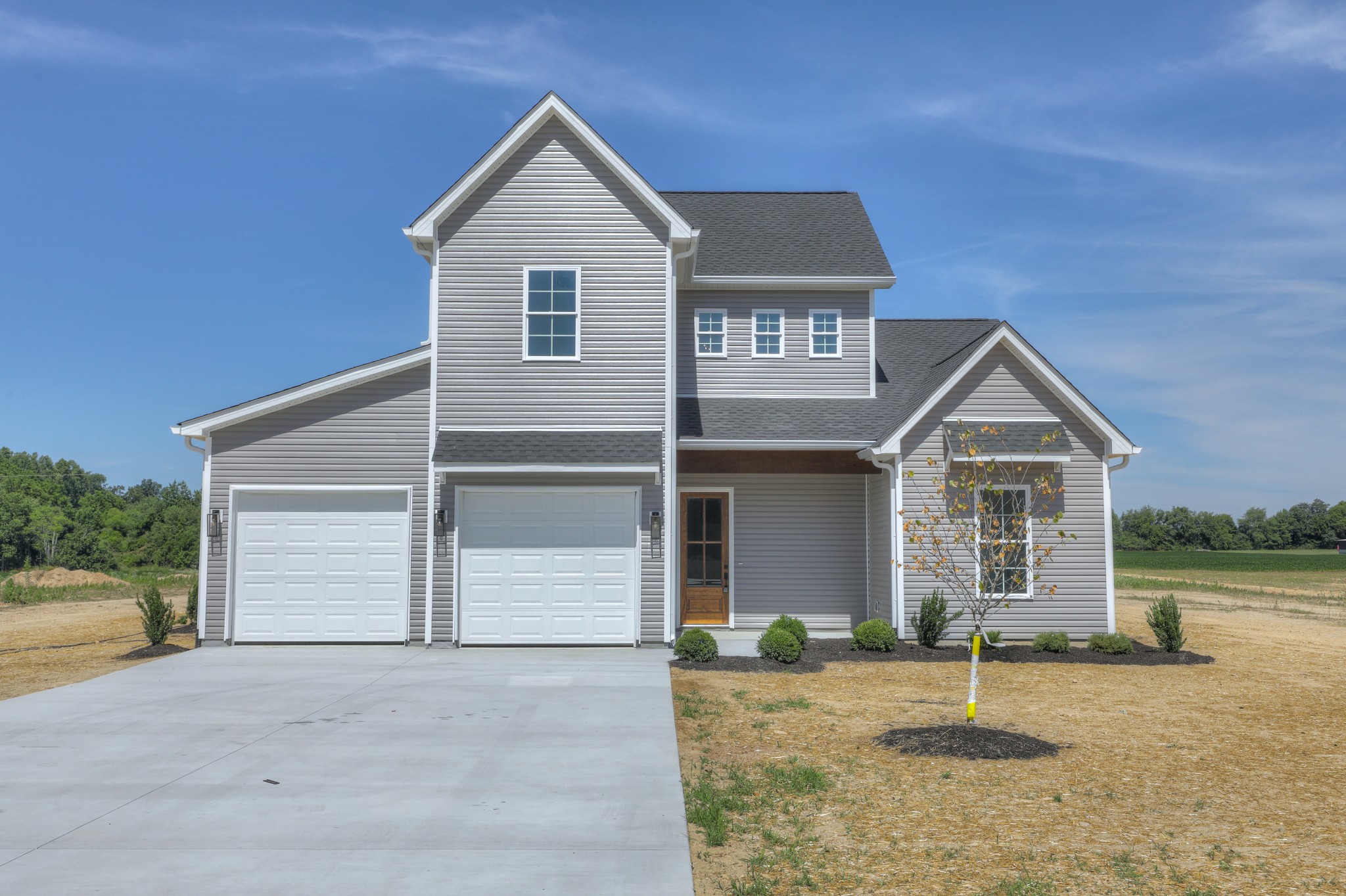 1221 Norton Road Manchester, TN 37355 - Photo 7 of 34 a front view of a house with a yard and garage