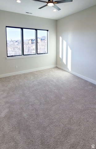1303 East Lasso Trail, Unit R6 Kamas, UT 84036 - Photo 8 of 31 Expansive room featuring plush wall-to-wall carpeting, a multi-pane window with black trim, a ceiling fan with integrated lighting, recessed lighting, and crisp white trim