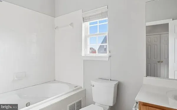 a bathroom with a bathtub and a toilet