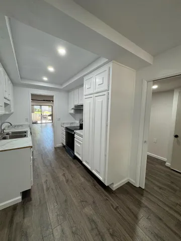 a view of a kitchen with wooden floor