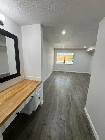 a view of an empty room and wooden floor