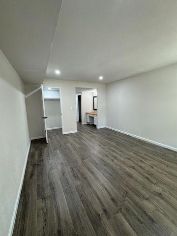 a view of hallway with wooden floor