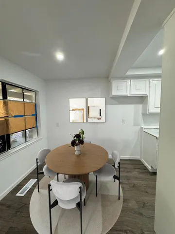 a view of a dining room with furniture and wooden floor