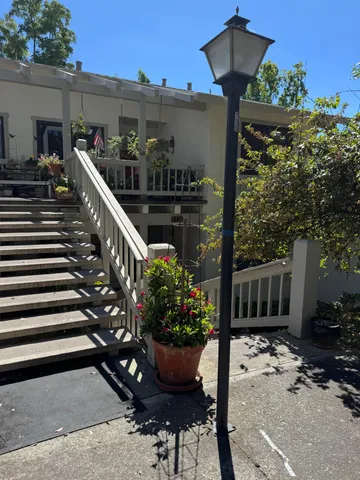 a view of a house with backyard and sitting area