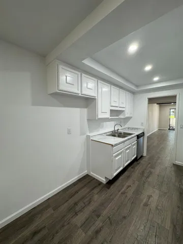 a large kitchen with a stove and refrigerator