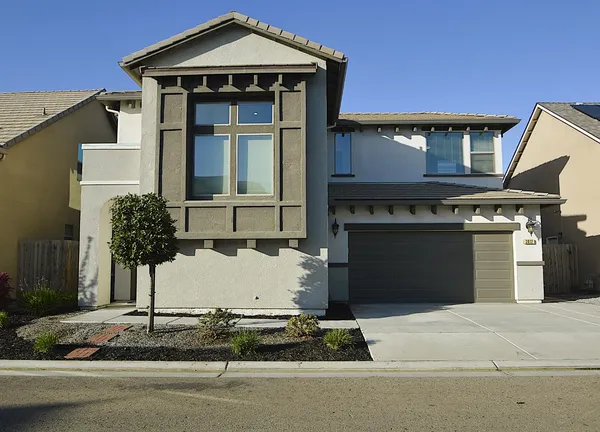 a front view of a house with garage